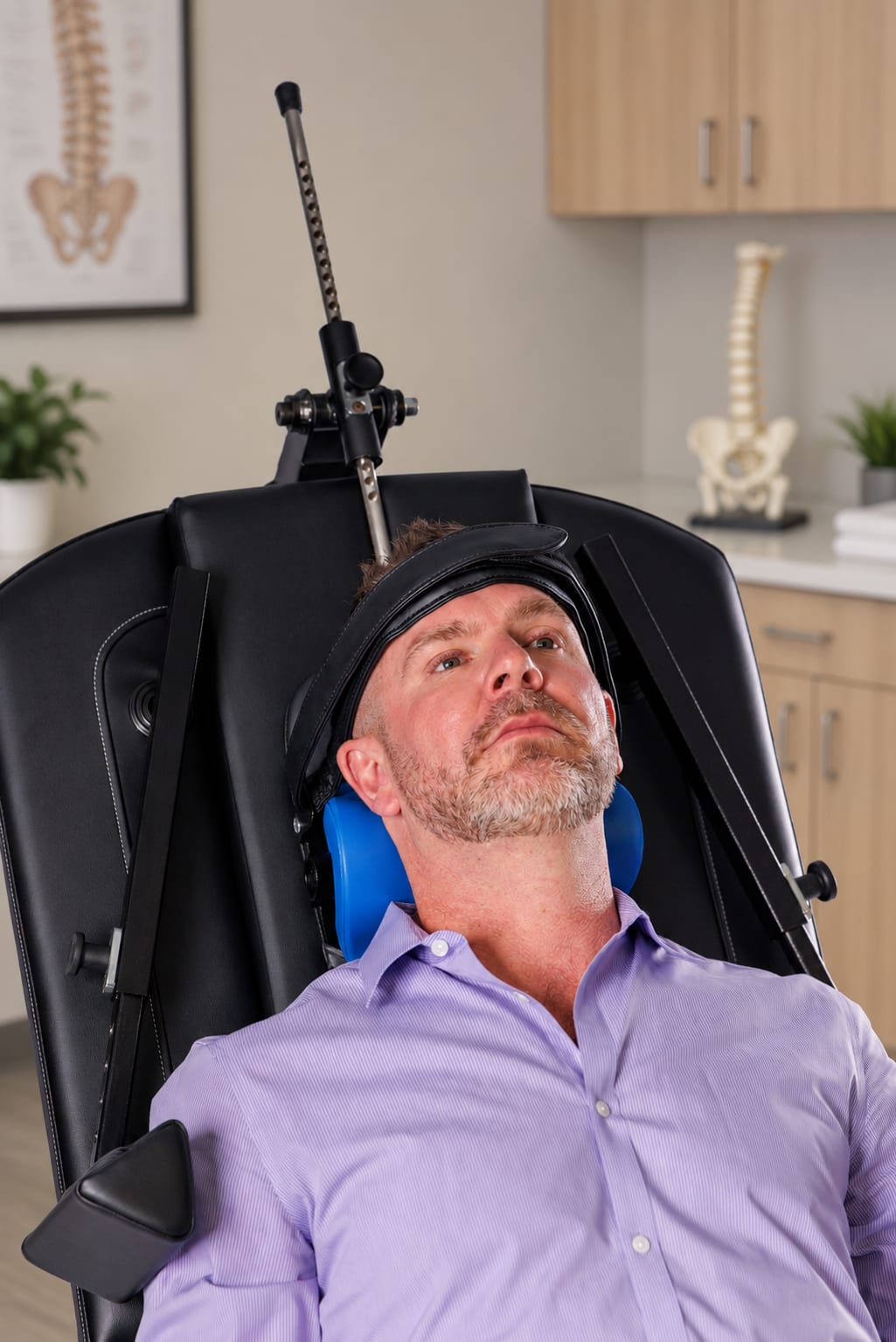 A patient reclined in the treatment chair with treatment directed at the neck