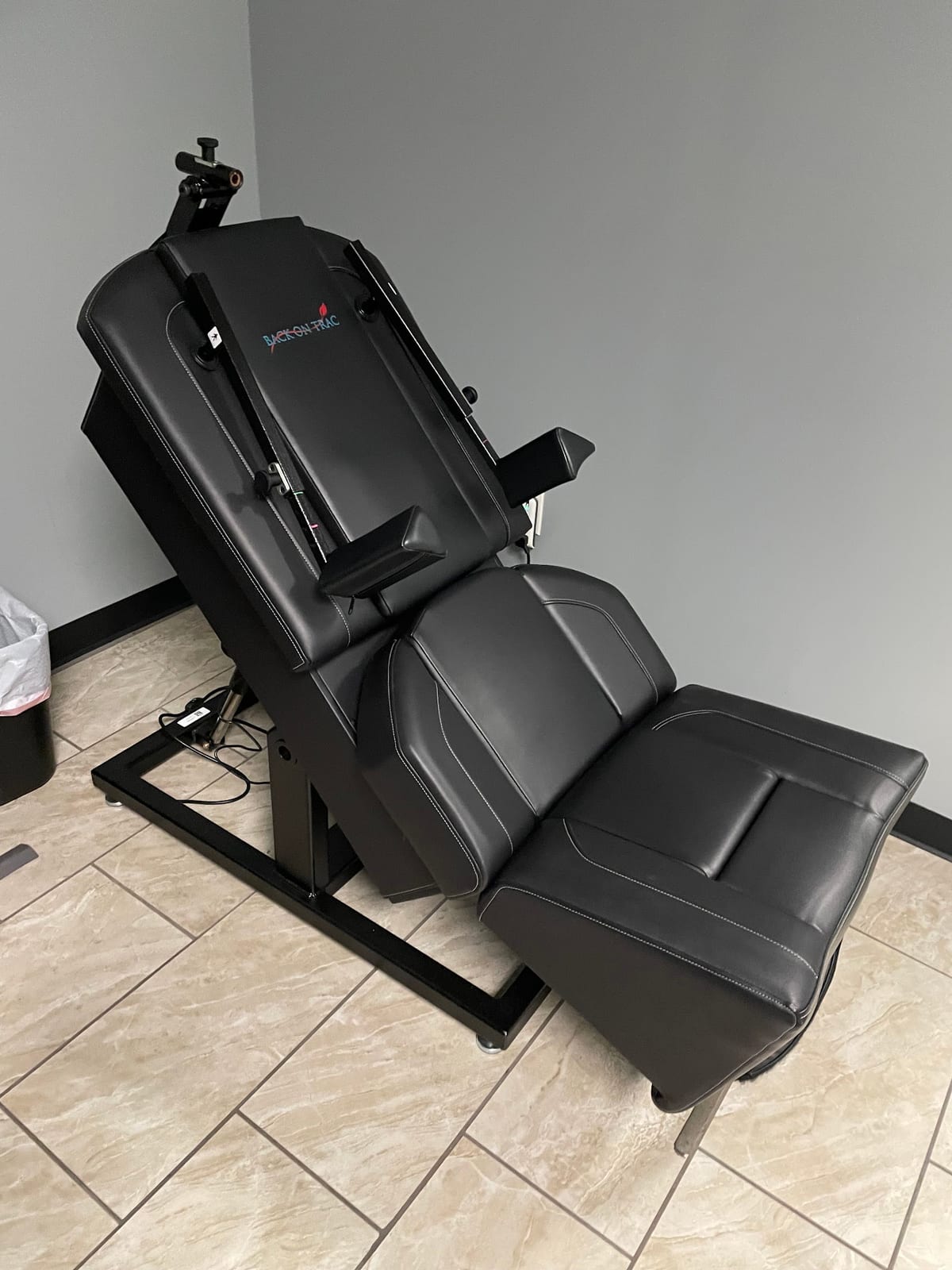 A treatment chair in an upright position in a treatment room at the clinic
